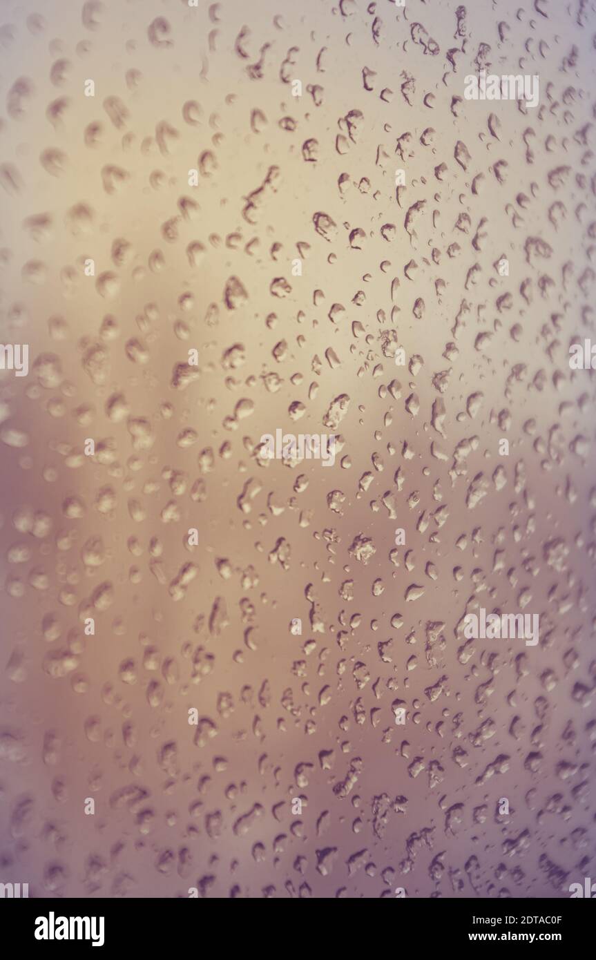 Melting snow on the glass, drops of water condensation on the window