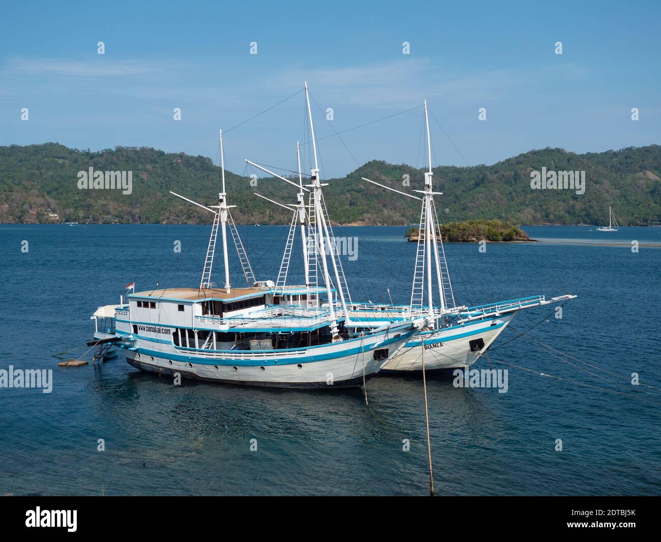 Liveaboard diving boats moored at the Lembeh Strait between Bitung on North Sulawesi and Lembeh Island in Indonesia. The Lembeh Strait is known for it Stock Photo