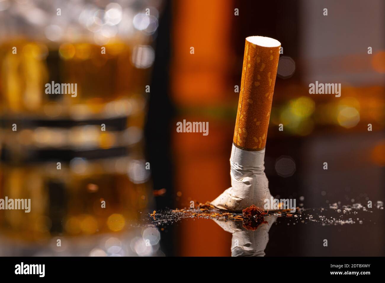 Extinguished cigarette butt on black table close up Stock Photo