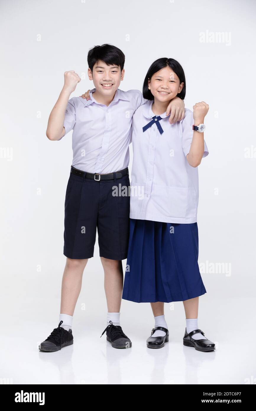 Portrait Of Smiling Boy And Girl With Arms Around Standing Against ...