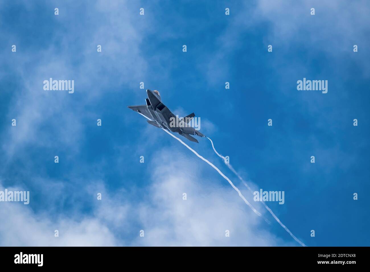 Lockheed Martin F-22 Raptor flying against sky Stock Photo