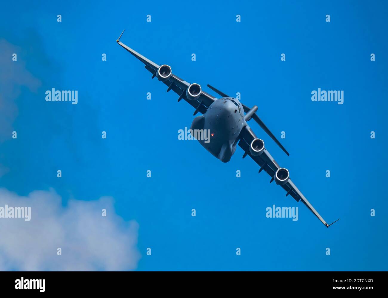 McDonnell Douglas/Boeing C-17 Globemaster III American Air Force cargo plane flying against sky Stock Photo