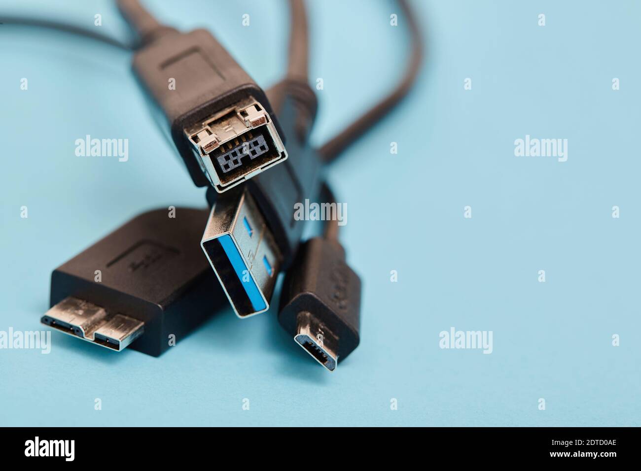 USB cables on blue background Stock Photo