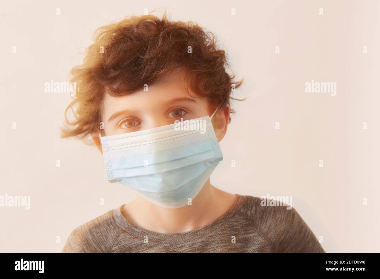 Boy (8-9) wearing protective face mask Stock Photo