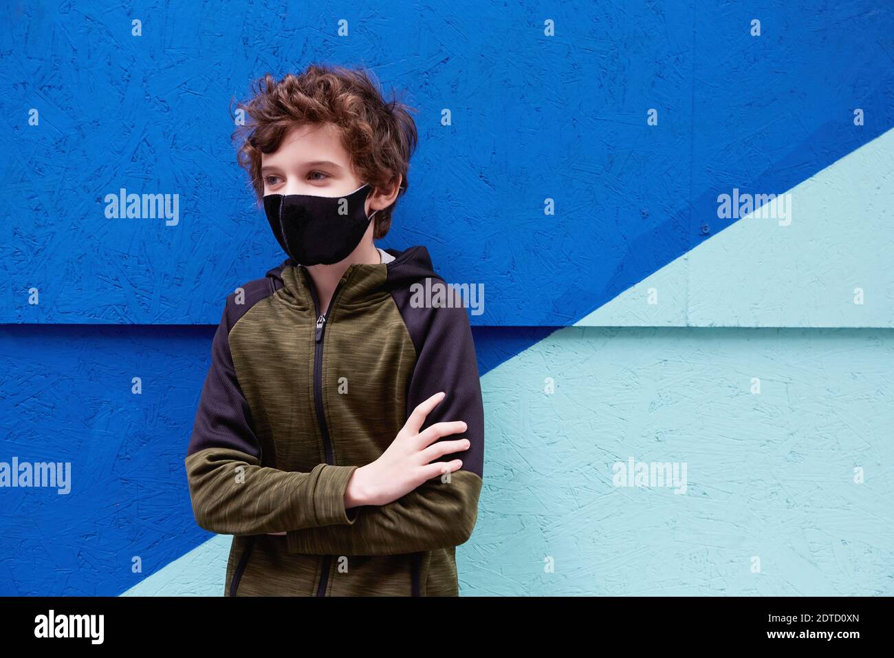 Boy (8-9) wearing protective face mask Stock Photo