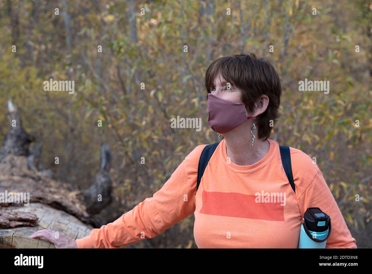 WOMAN HIKER WITH FACE MASK, BANDELIER NATIONAL MONUMENT, NM, USA Stock Photo