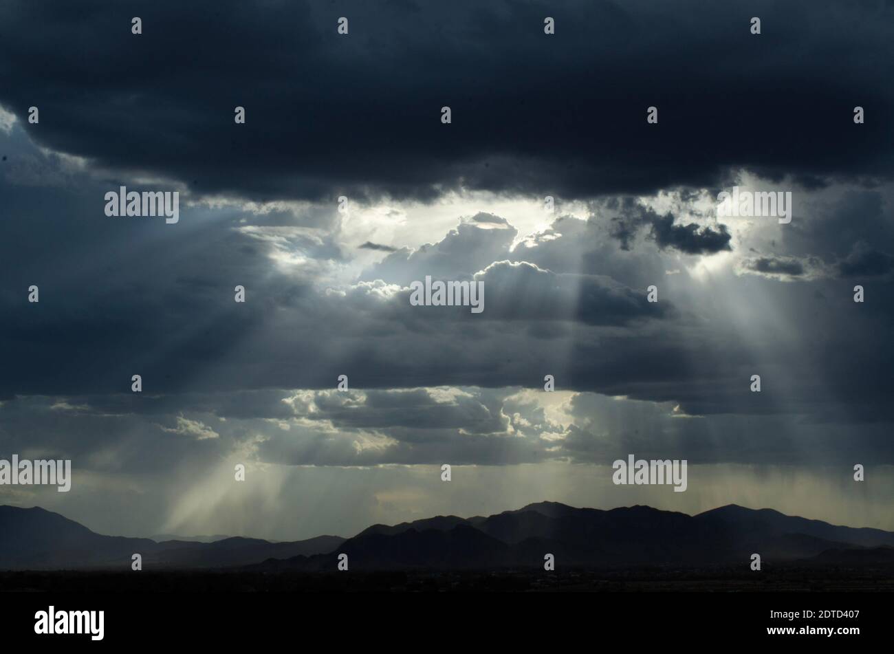 Cloudy Sky Rain Falling And God Rays Breaking Over Mountain Mojave Desert, Pahrump, Nevada, Usa