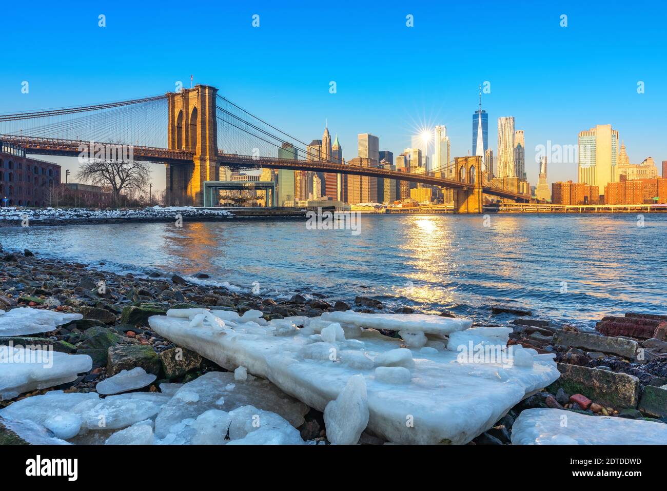 Brooklyn bridge East river and Manhattan at winter sunrise, New York City Stock Photo