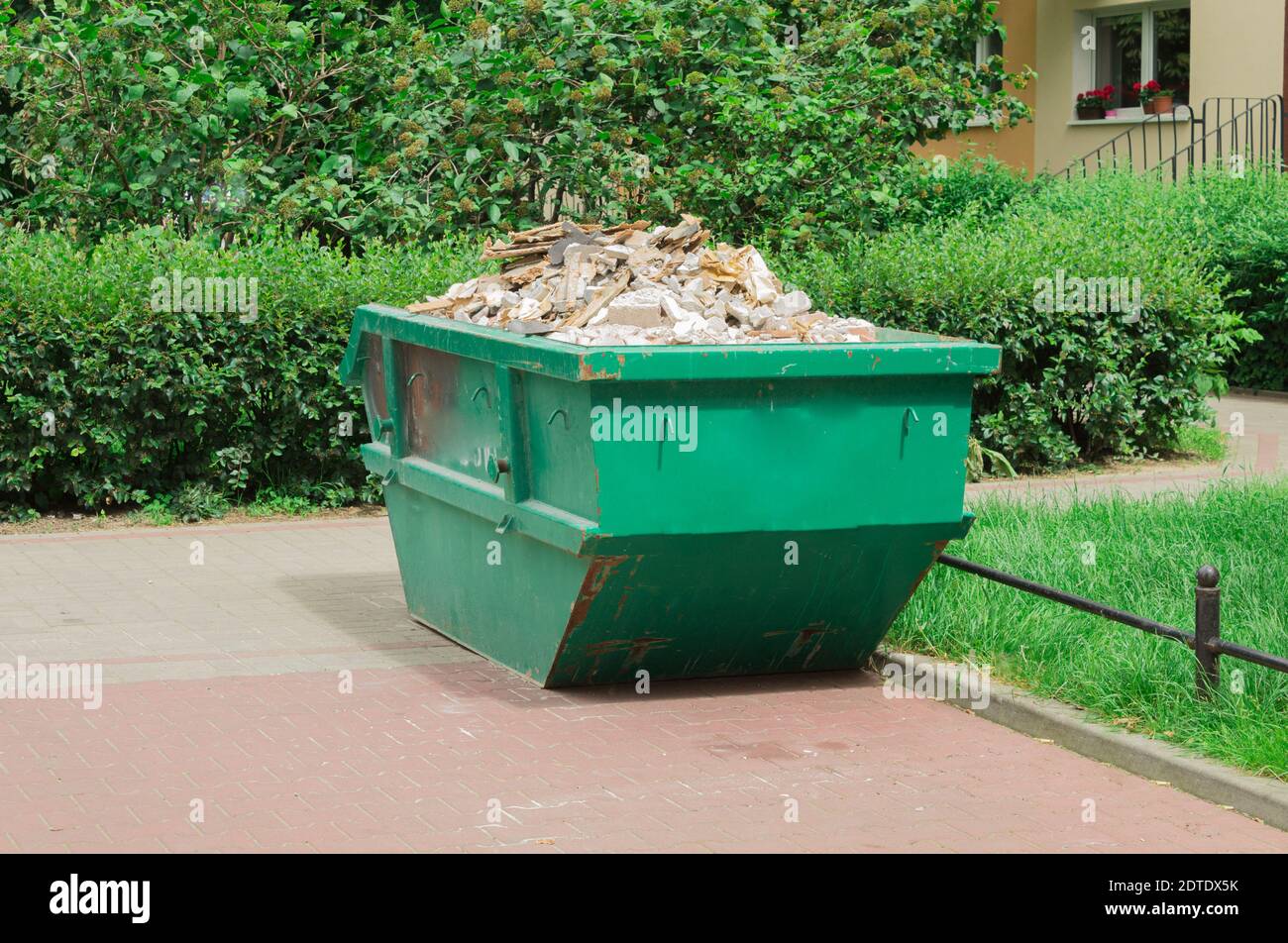 Container with solid household and construction waste. Waste recycling. Caring for the