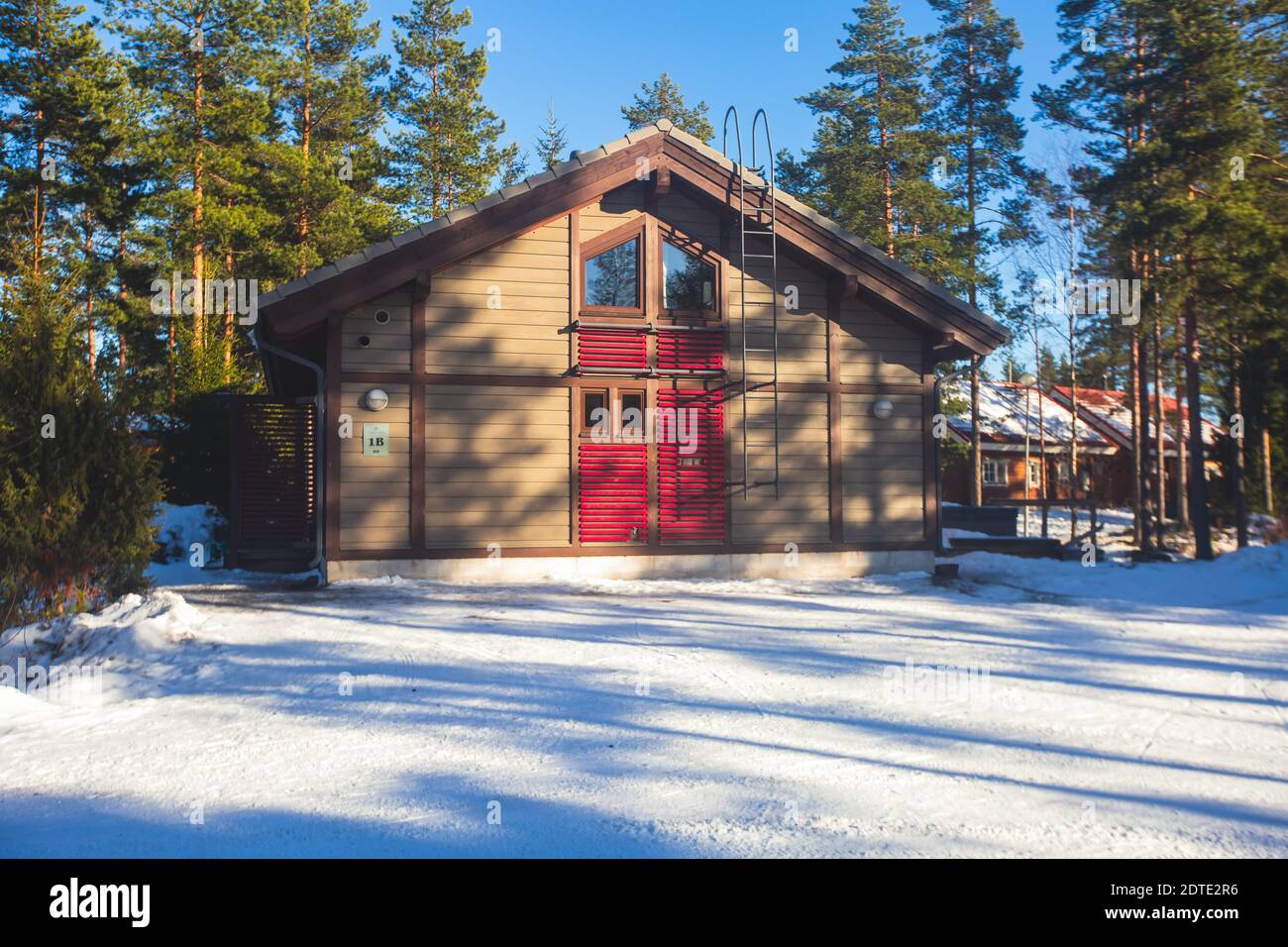 A view of cozy wooden scandinavian cabin cottage chalet house covered ...