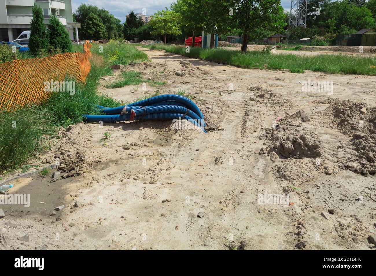 Laying of underground utilities. PVC corrugated hose for laying electric cables and fiber, Construction work on laying of communications Stock Photo