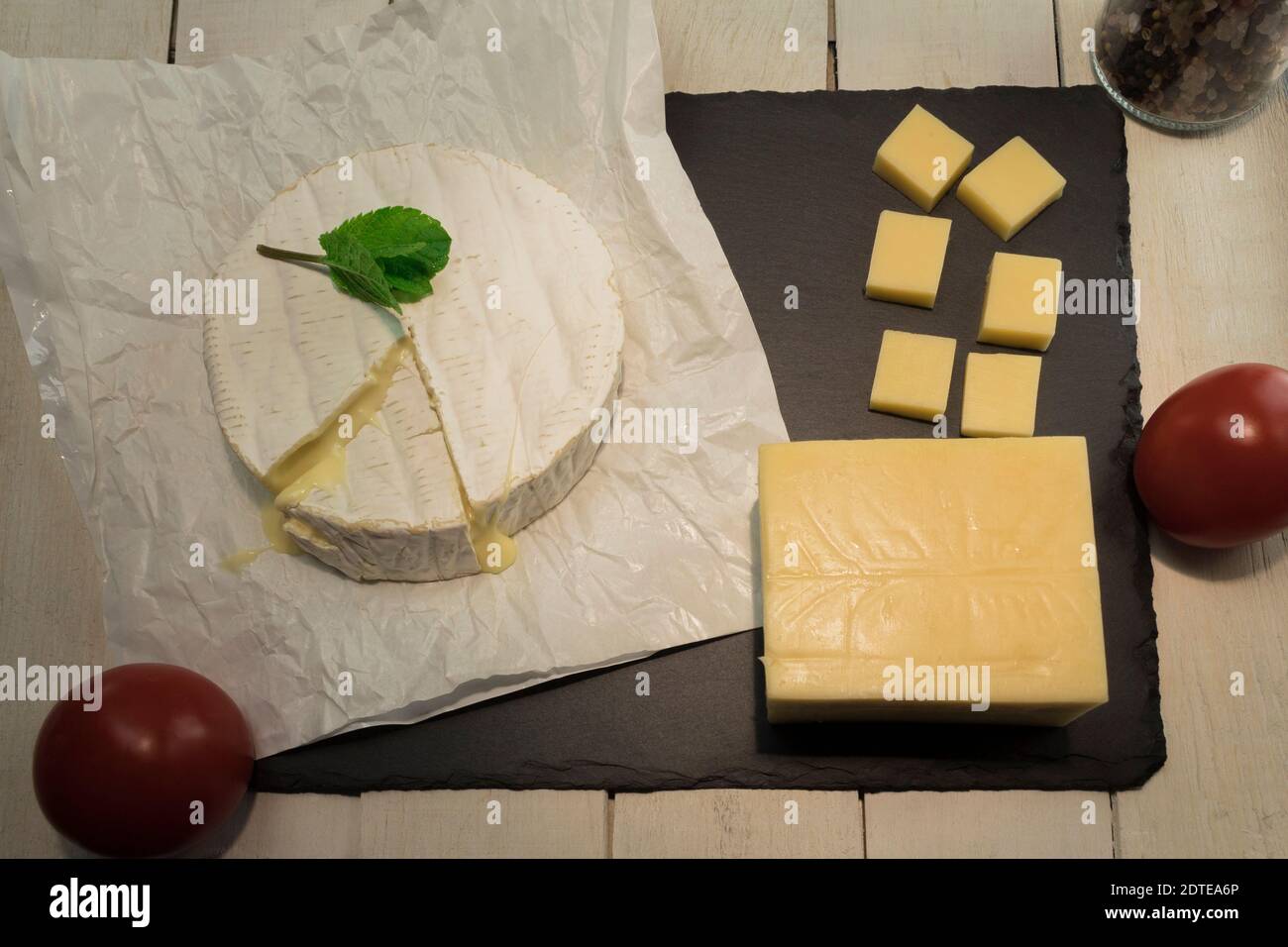 The process of making sandwiches. Ingredients for sandwiches, cheeses and vegetables. Diced