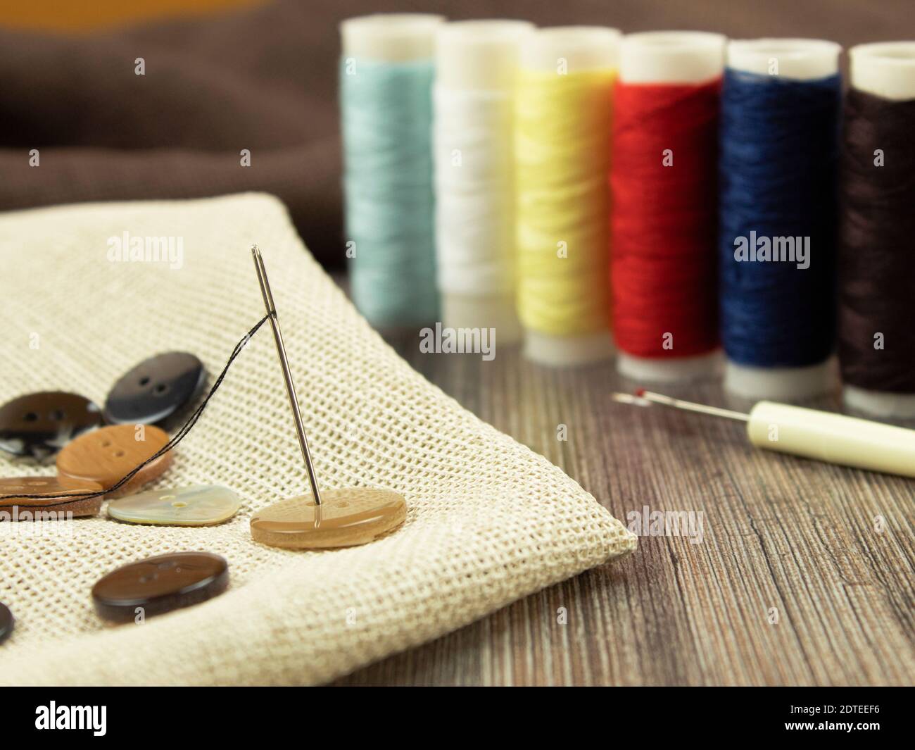 Background for text multicolored threads and needle for needlework