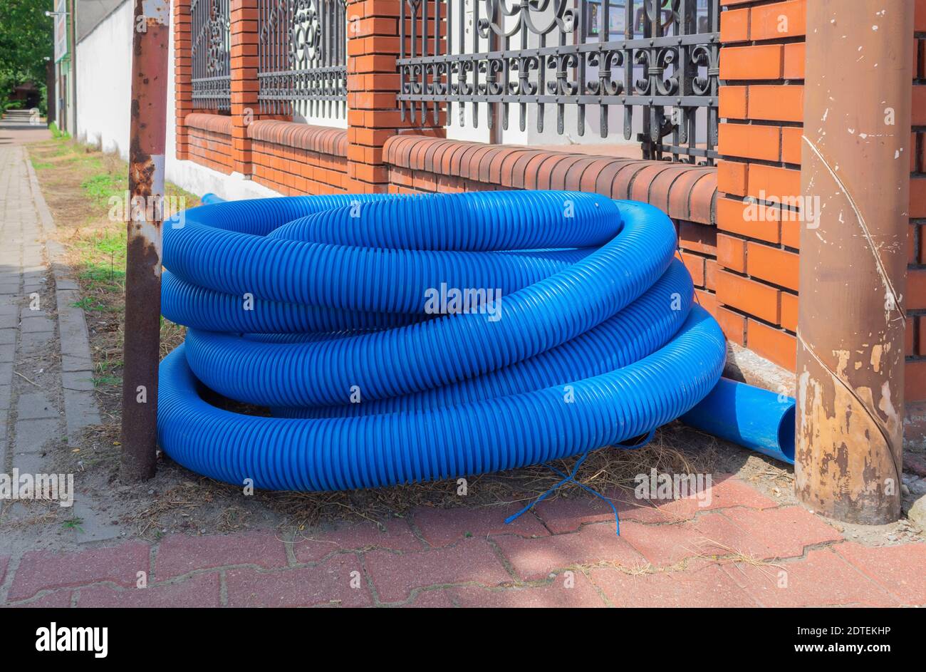 Corrugated pipe twisted into a roll. Blue corrugated pipe lies on the