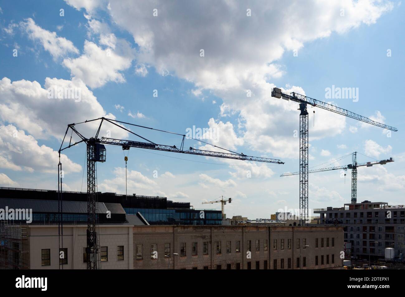 Four tower cranes against the sky. Crane for lifting building materials ...