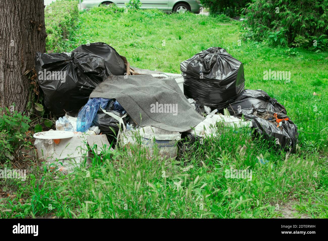 Loads of Trash Bags Sitting Out on the Curb Near a Tree with a Black Picket  Fence and Shrub Background in Urban or Stock Photo - Image of hand, trash:  263643134