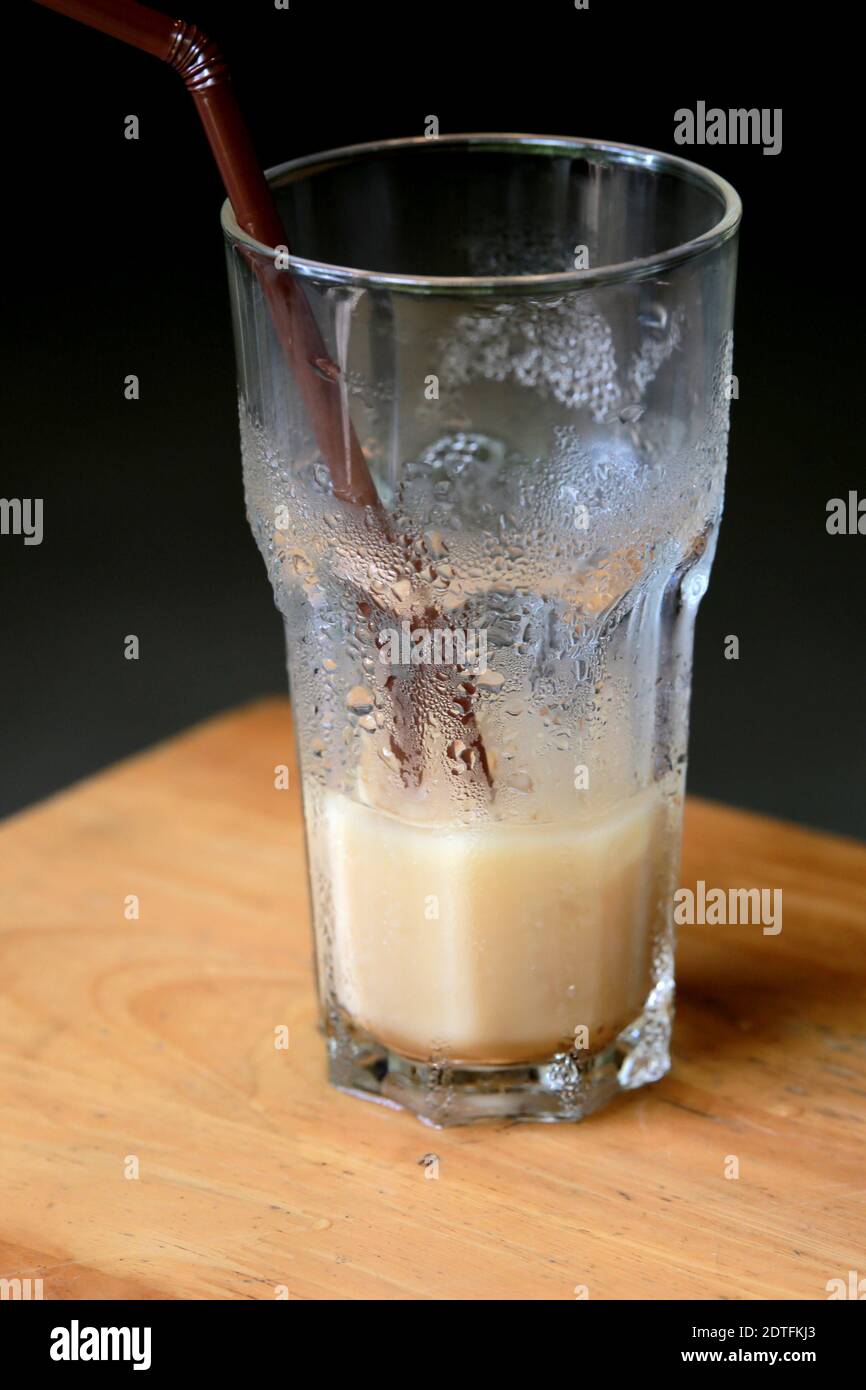 Close Up Of Half Full Iced Coffee Glass On Wooden Table Stock Photo Alamy