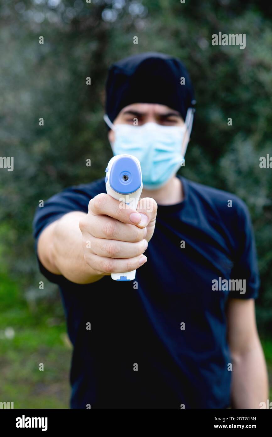 Doctor taking temperature with infrared thermometer Stock Photo Alamy