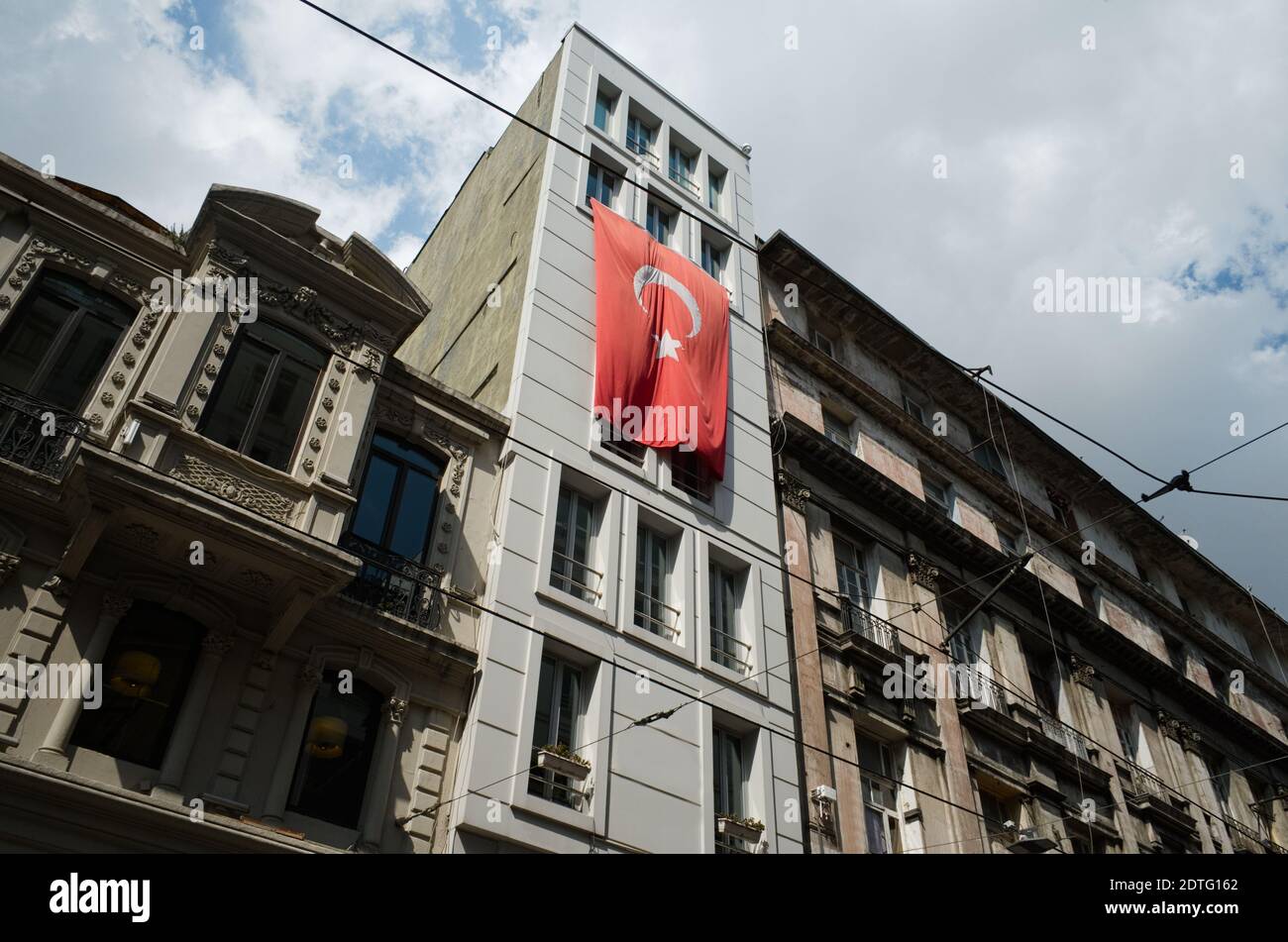 Big Turkish flag hanging on the old historical building on the Istiklal street. Istanbul, Turkey. Stock Photo