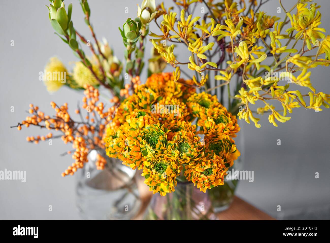 Set of yellow nd orange flowers for Interior decorations. The work of the florist at a flower shop. Fresh cut flower. European floral shop. Delivery Stock Photo