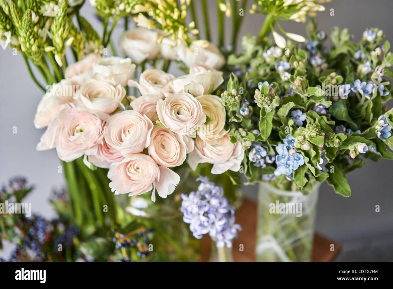 Set of white and blue flowers for Interior decorations. The work of the florist at a flower shop. Fresh cut flower. European floral shop. Delivery Stock Photo
