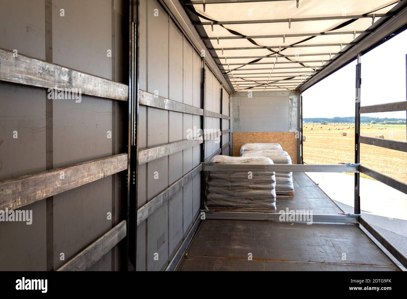 Loading into a tilt trailer of a truck. The process of unloading goods from a large truck Stock Photo