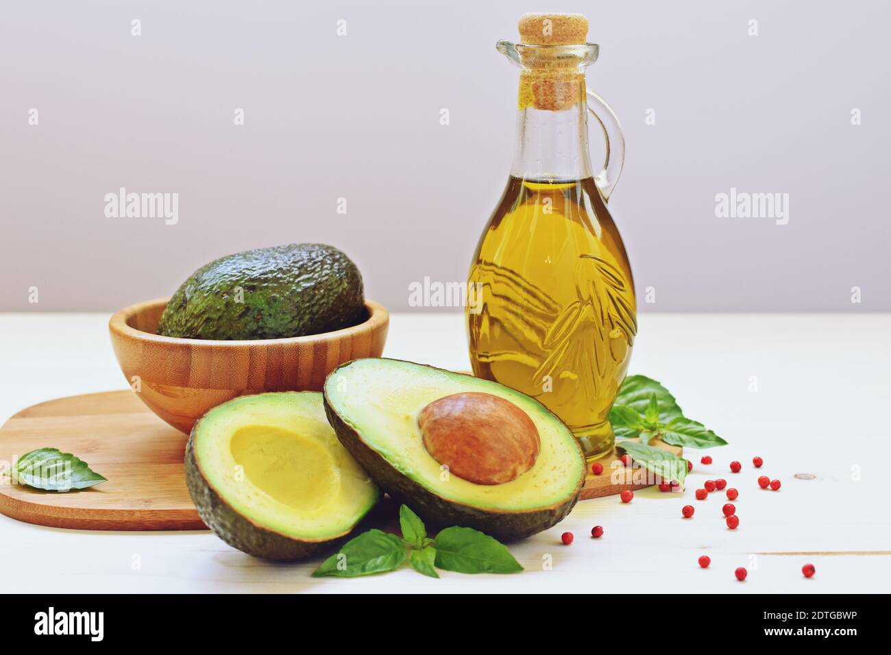 Concept of vegetarian food with avocado and olive oil on white background. Stock Photo