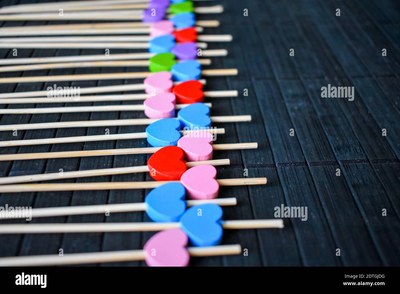 Decorative wooden sticks in a row Stock Photo - Alamy