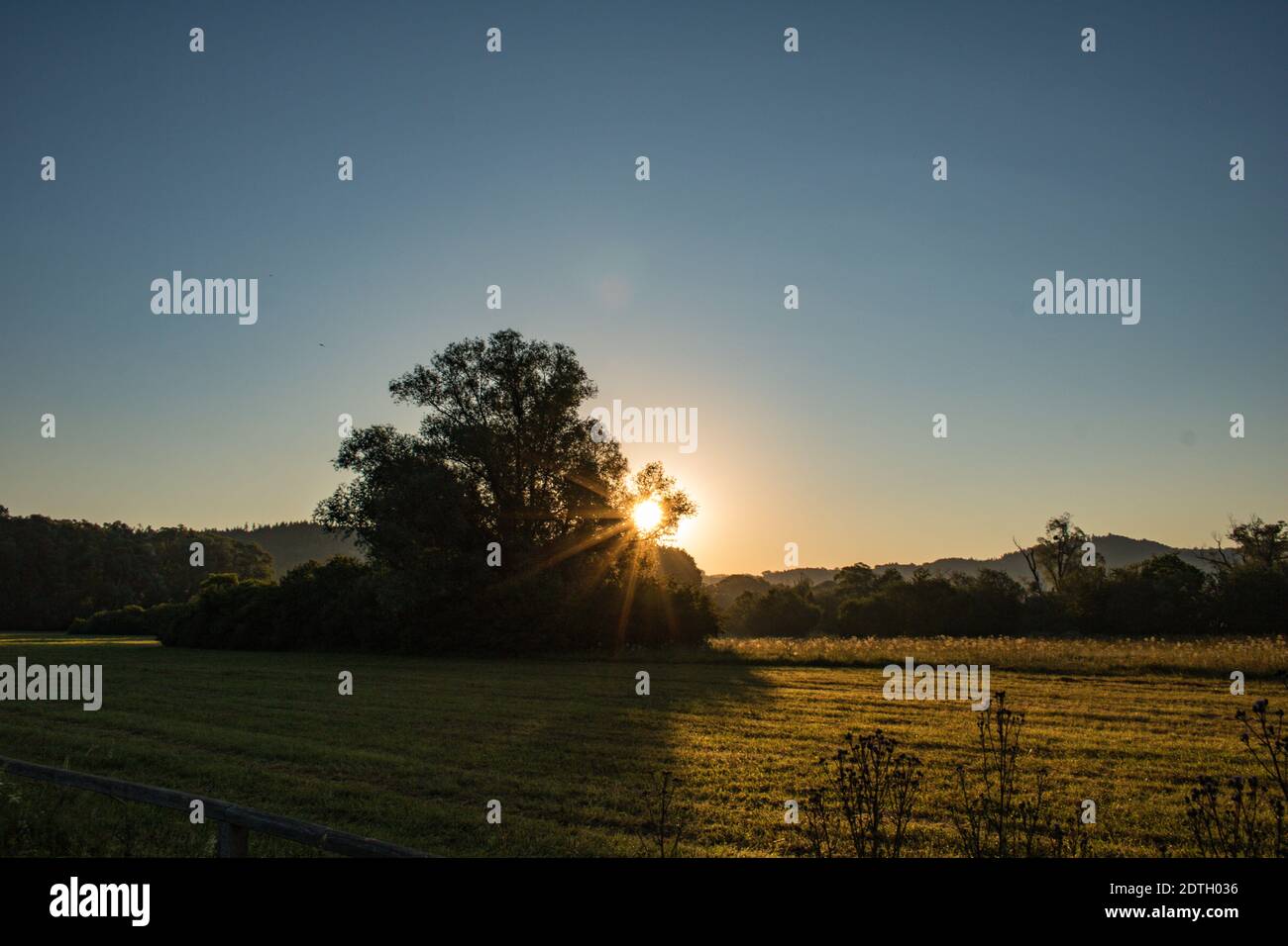 Scenic View Of Agricultural Field Against Clear Sky During Sunset Stock Photo