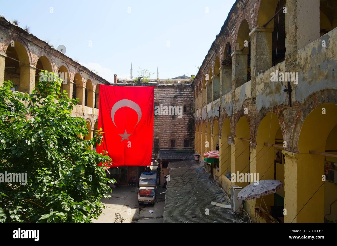 Istanbul, Turkey - September, 2018: Large hanging Turkish flag in the courtyard of old historic building on Grand Bazaar in Istanbul. Stock Photo