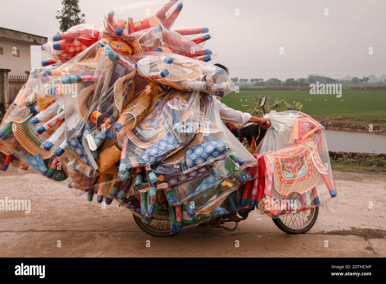 Vietnamese motorbike overloaded with cargo, shows the local culture and daily life in the countrysides of Vietnam Stock Photo