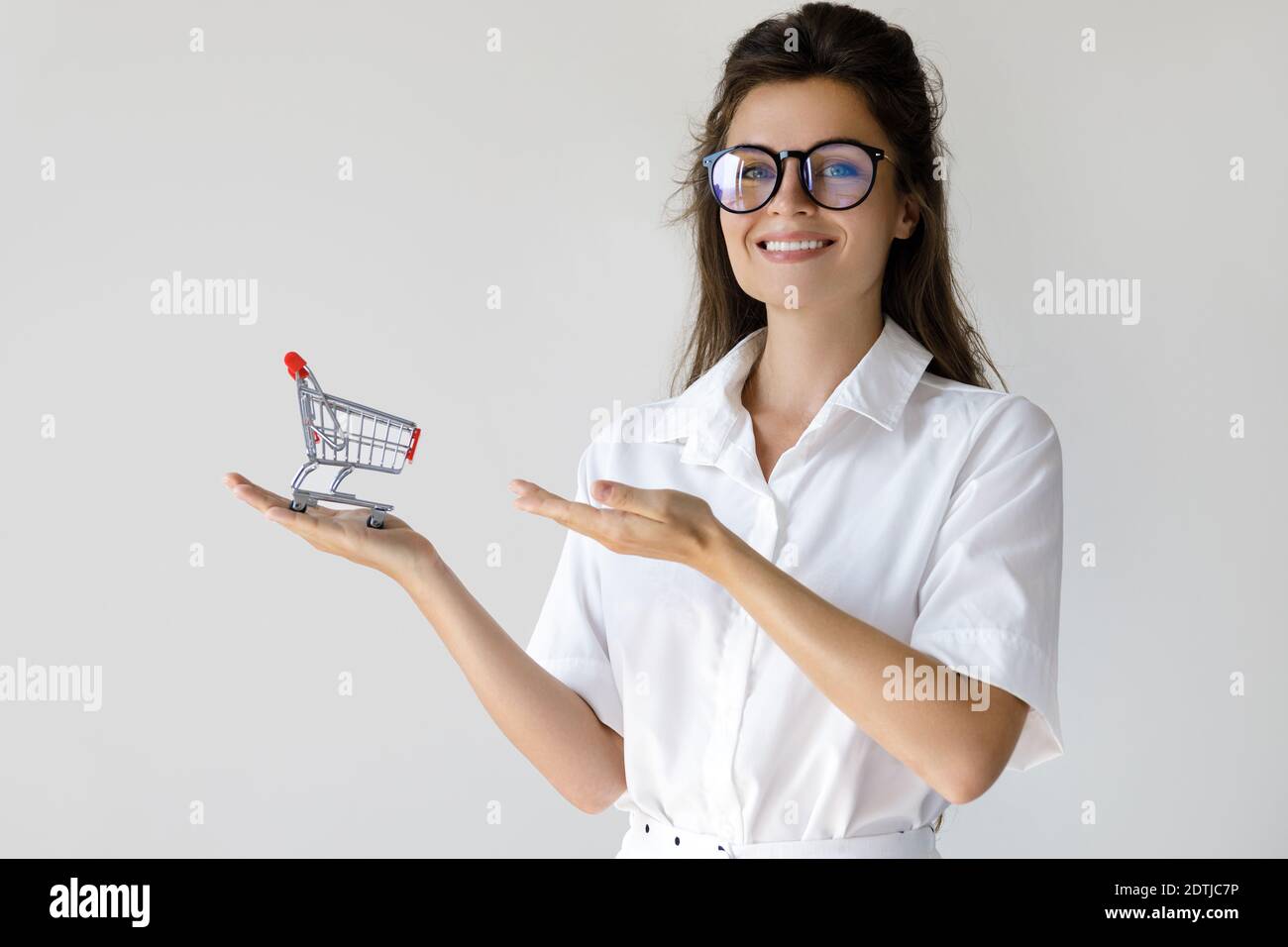 Buying and selling concept. Woman with a little shopping cart in her hand Stock Photo