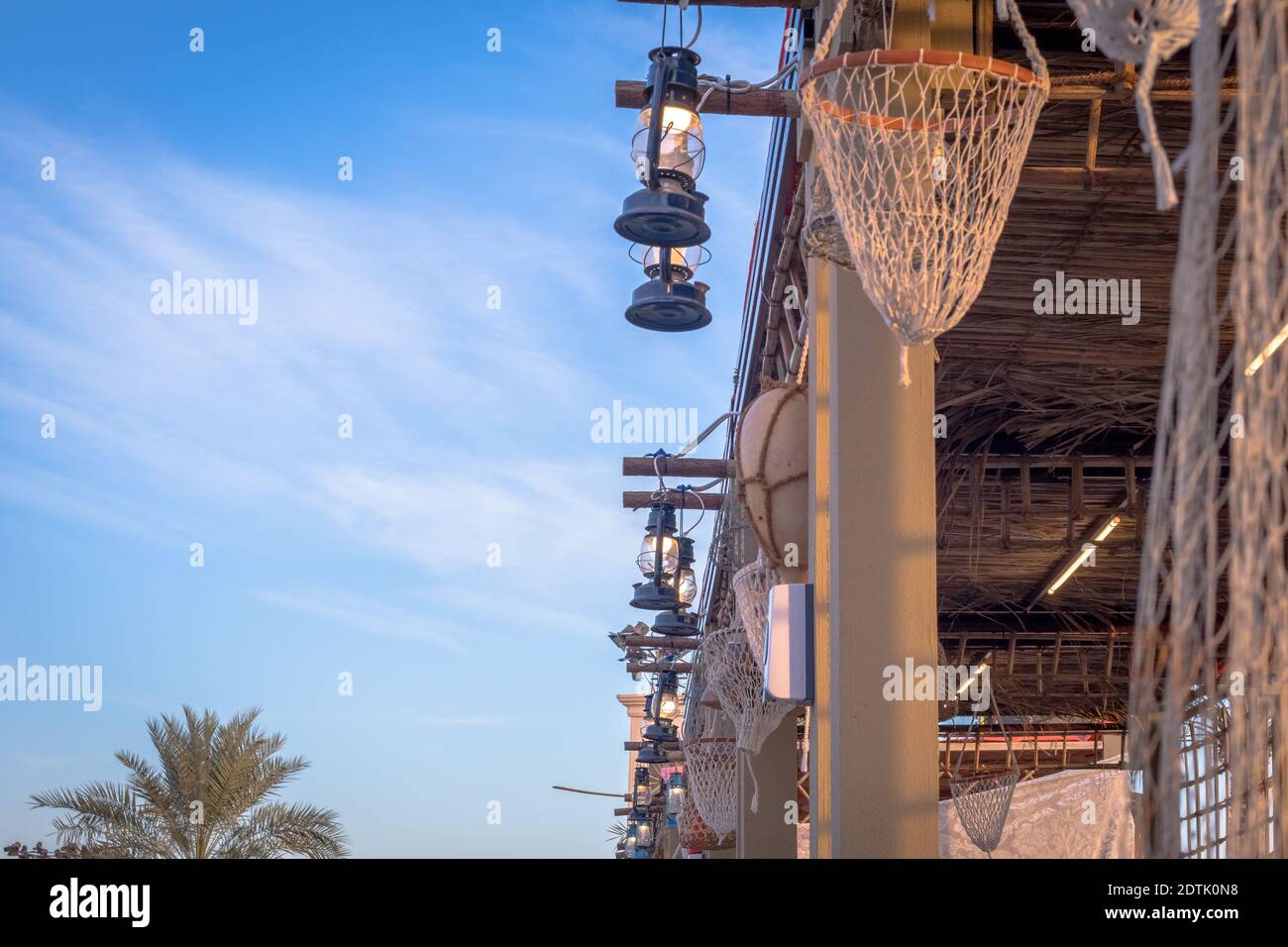 Arabic street lanterns hanging on wooden pole,View of Abu Dhabi, United