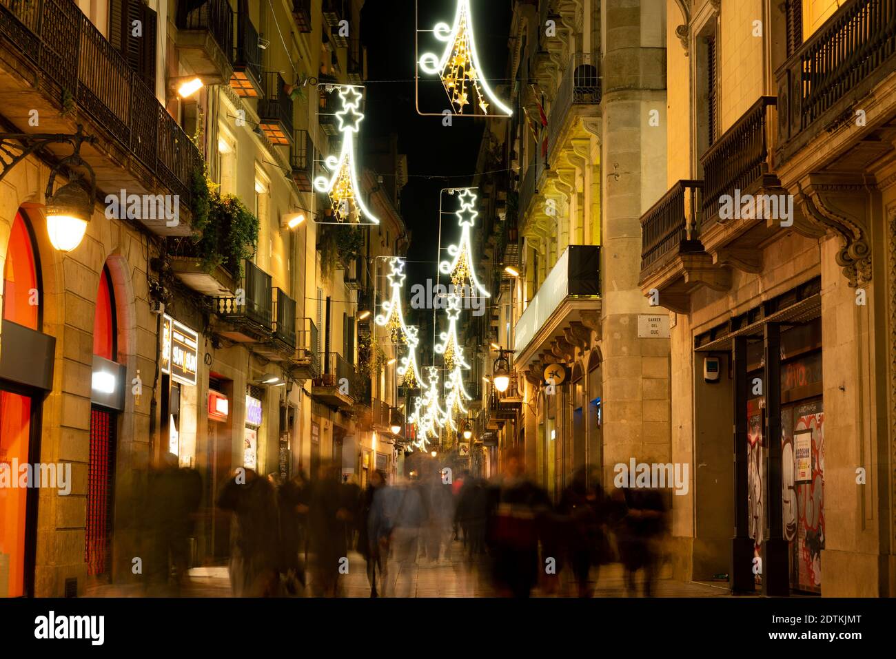 barcelona, spain - 3 december 2020: christmas time in barcelona during covid19. christmas lights and people walking in the city center at night doing Stock Photo