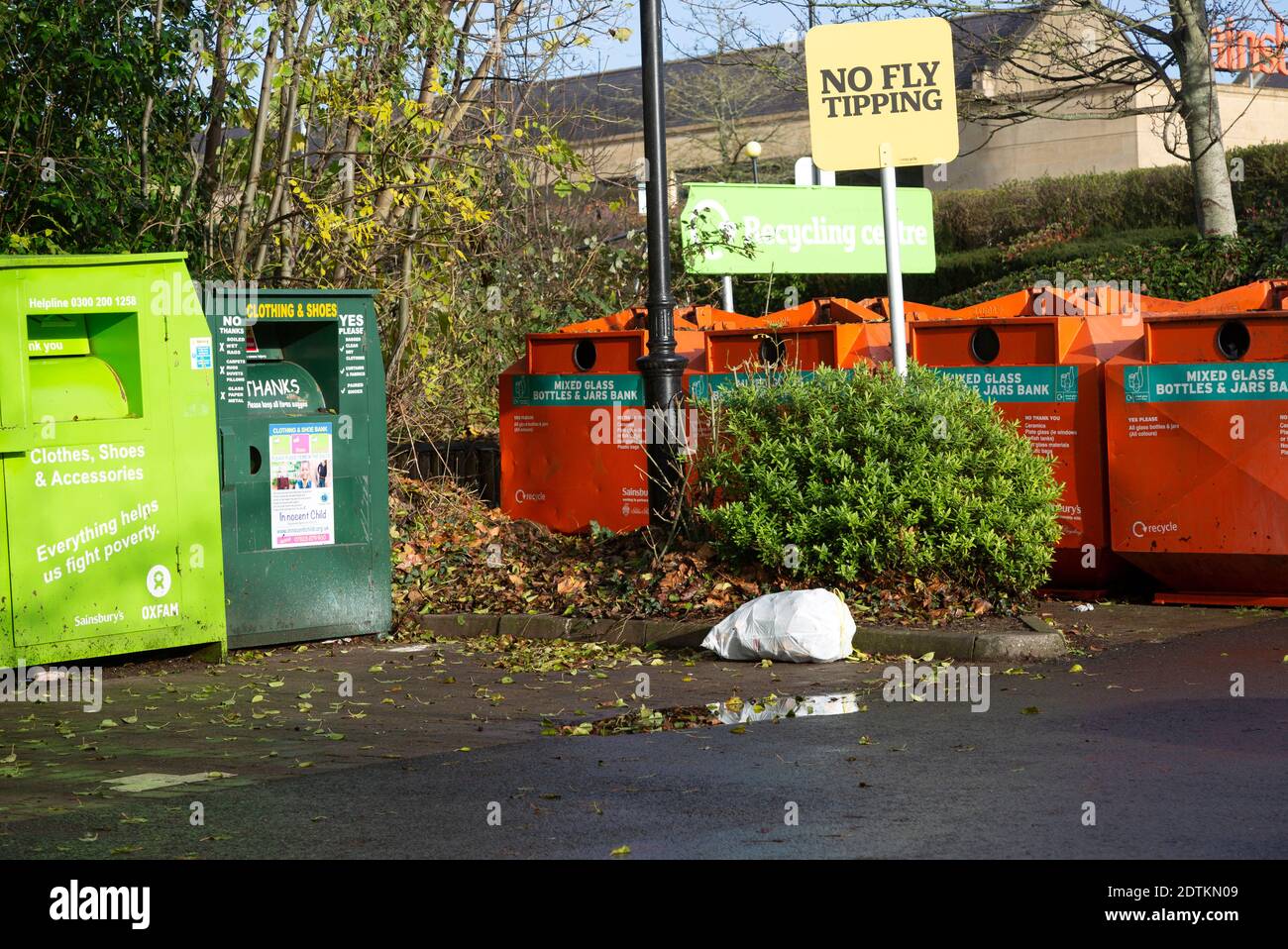 Rubbish bag dumped beneath No Fly Tipping sign, Sainsbury's recycling centre, Calne, England Stock Photo