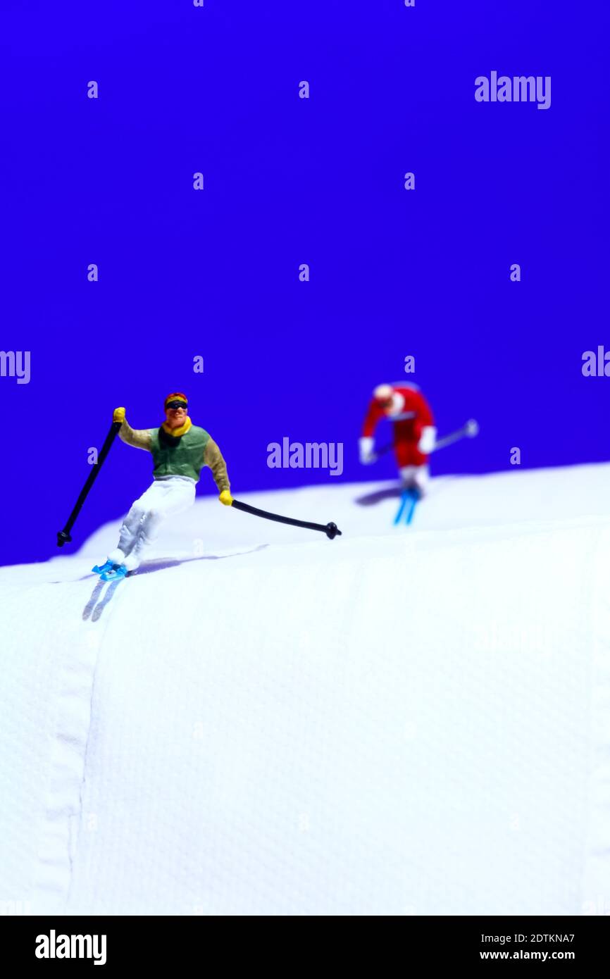 Miniature people, Skier playking ski on snow stream. Image use for sport  ,travel concept. Stock Photo