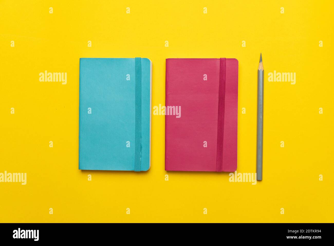 Directly Above Shot Of Diaries On Yellow Background Stock Photo