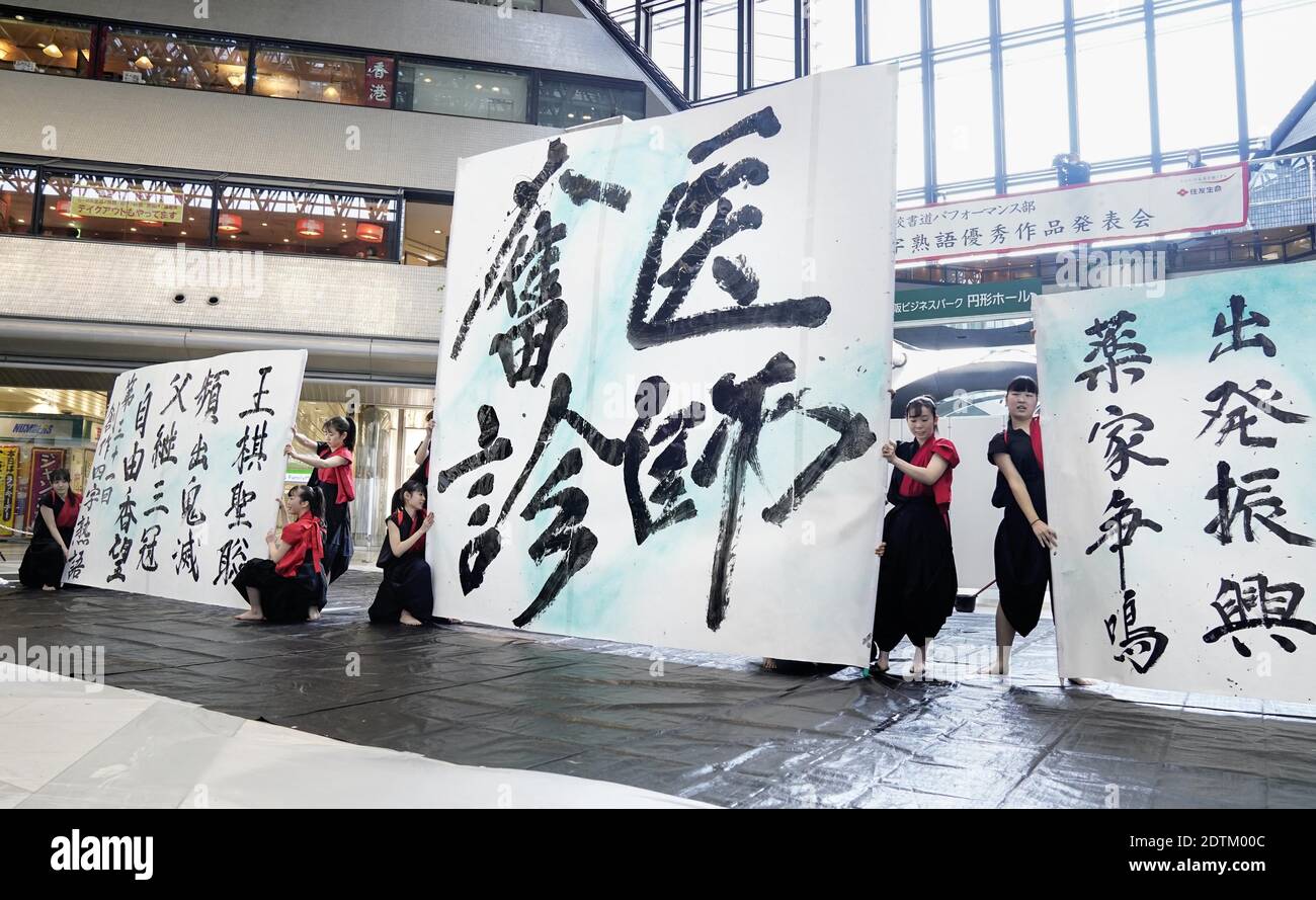 High School Students Pose Following A Calligraphy Performance In Osaka On Dec 22 The Winner Of An Earlier Contest On Creative Four Kanji Character Idioms To Characterize The Year Written In