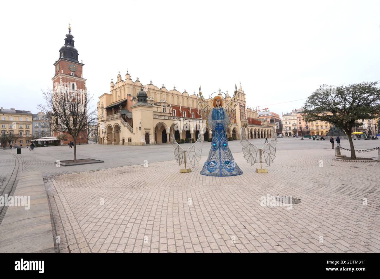 Cracow. Krakow. Poland. Deserted Main Market Place.Town Hall Tower (Wieza Ratuszowa) and Cloth Hall (Sukiennice). Covid second wave. Christmas decorat Stock Photo