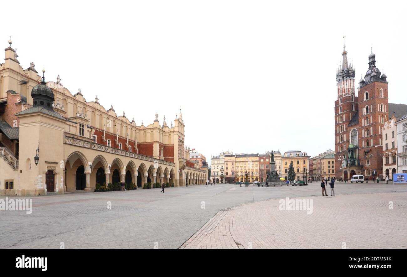 Cracow. Krakow. Poland. Deserted Main Market Place. Cloth Hall (Sukiennice) and St. Mary basilica (Kosciol Mariacki). Covid second wave. Stock Photo