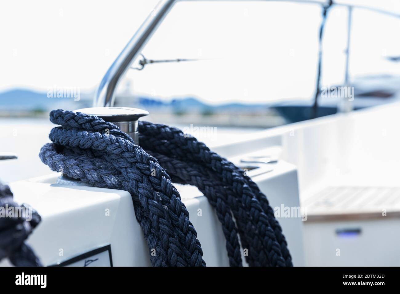 Detail of an anchor rope on a yacht. Mooring knot on the boat close up