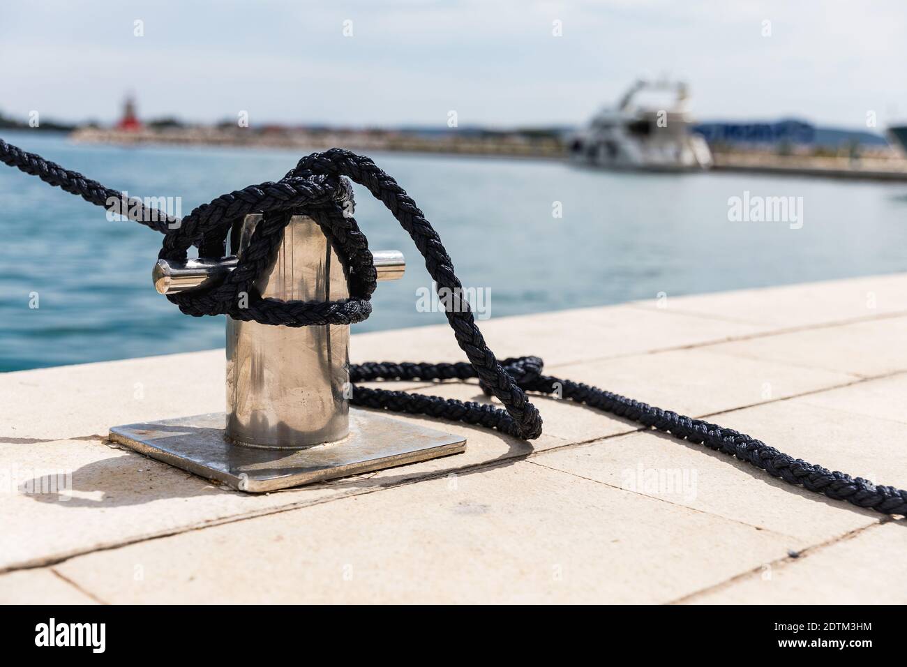 Detail of an anchor rope on a yacht. Mooring knot on the boat close up