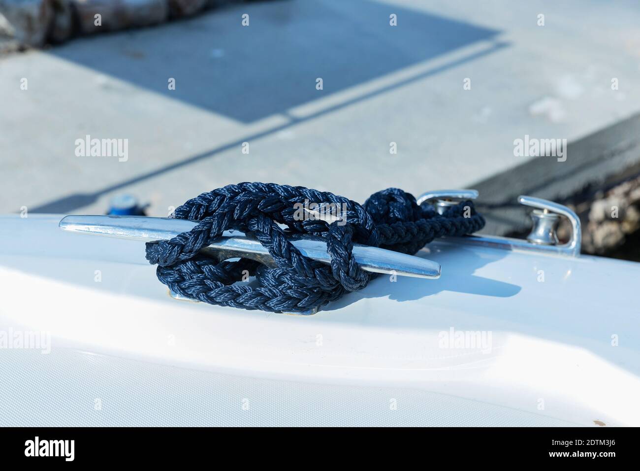 Detail of an anchor rope on a yacht. Mooring knot on the boat close up