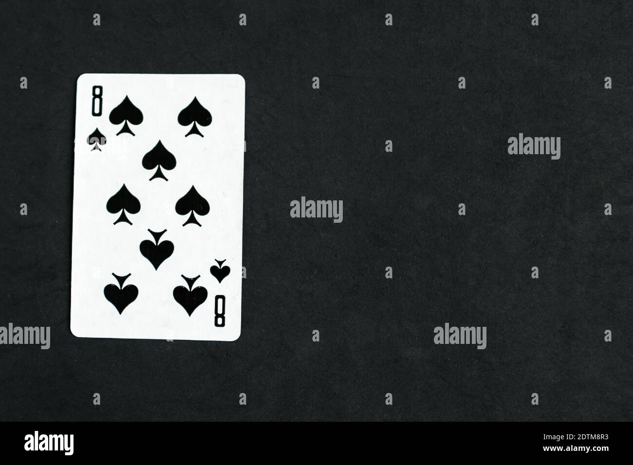 Eight of Spades playing card, black background, copy space Stock Photo