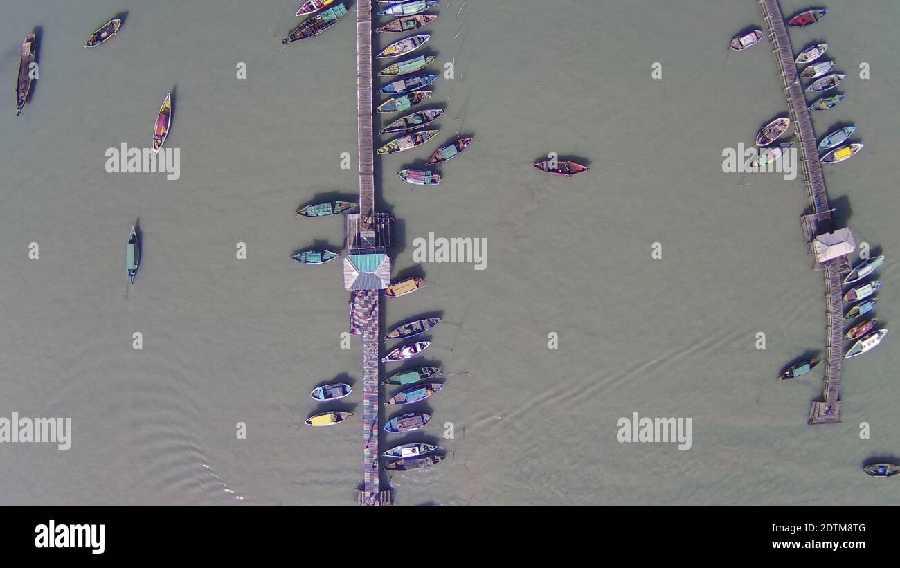 An aerial top view of many moored sailing boats lined up on the piers ...