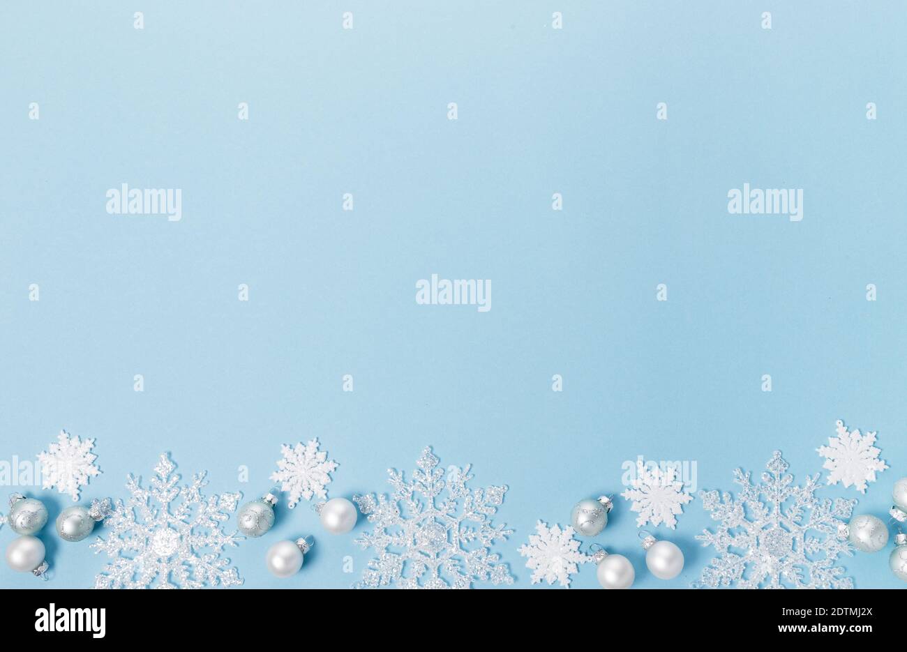 Blue Christmas holiday composition. Festive creative white pattern, xmas decor holiday ball with snowflakes on blue background. Stock Photo