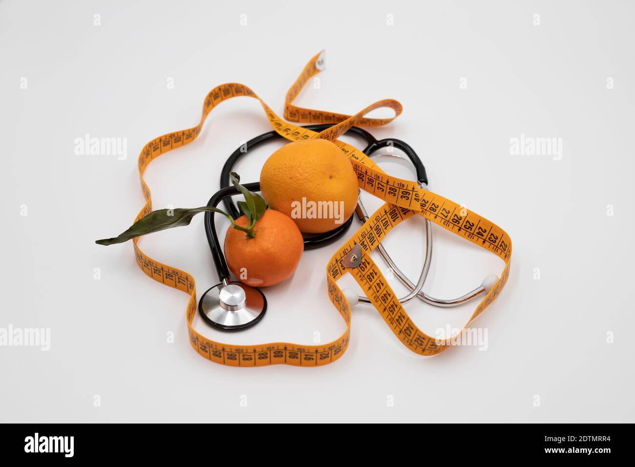 Orange stethoscope and a centimeter on white background Stock Photo