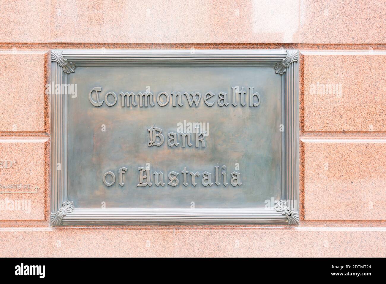 A large heritage item, bronze plaque for the Commonwealth Bank of Australia (CBA) outside one of its old branches in Sydney city, Australia Stock Photo
