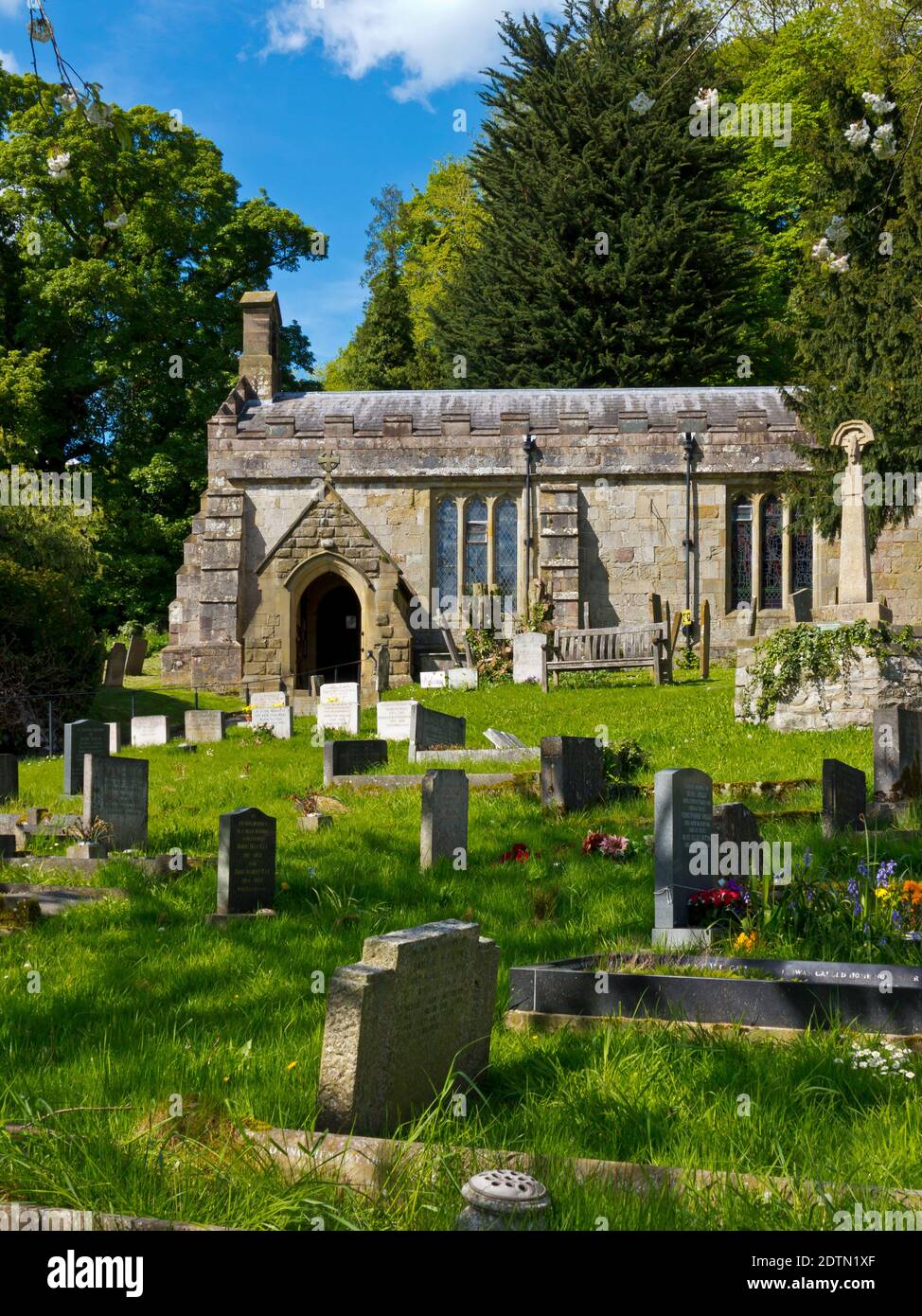 St Margaret's Church a thirteenth century Grade II listed parish church in Carsington Derbyshire Dales England UK with graveyard in foreground. Stock Photo