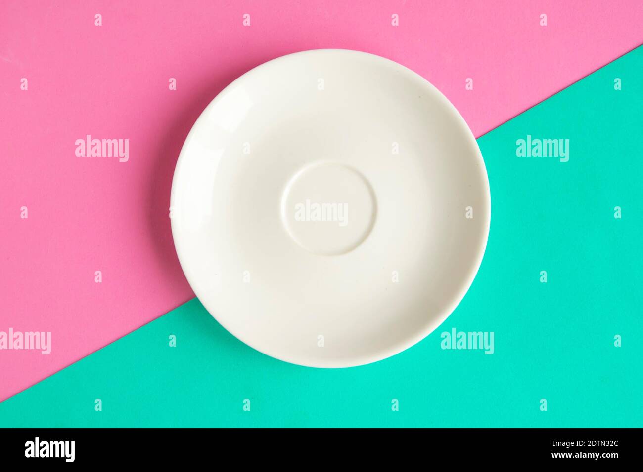 Empty plate on green and pink background. Copy space for the text ...